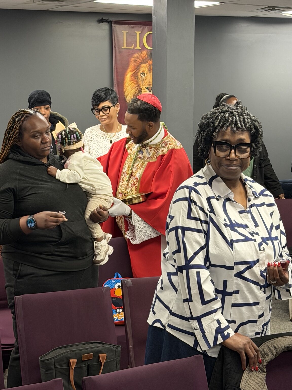 Bishop Brown serving a family during Holy Communion